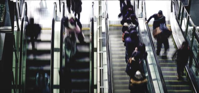 people running up and down escalators